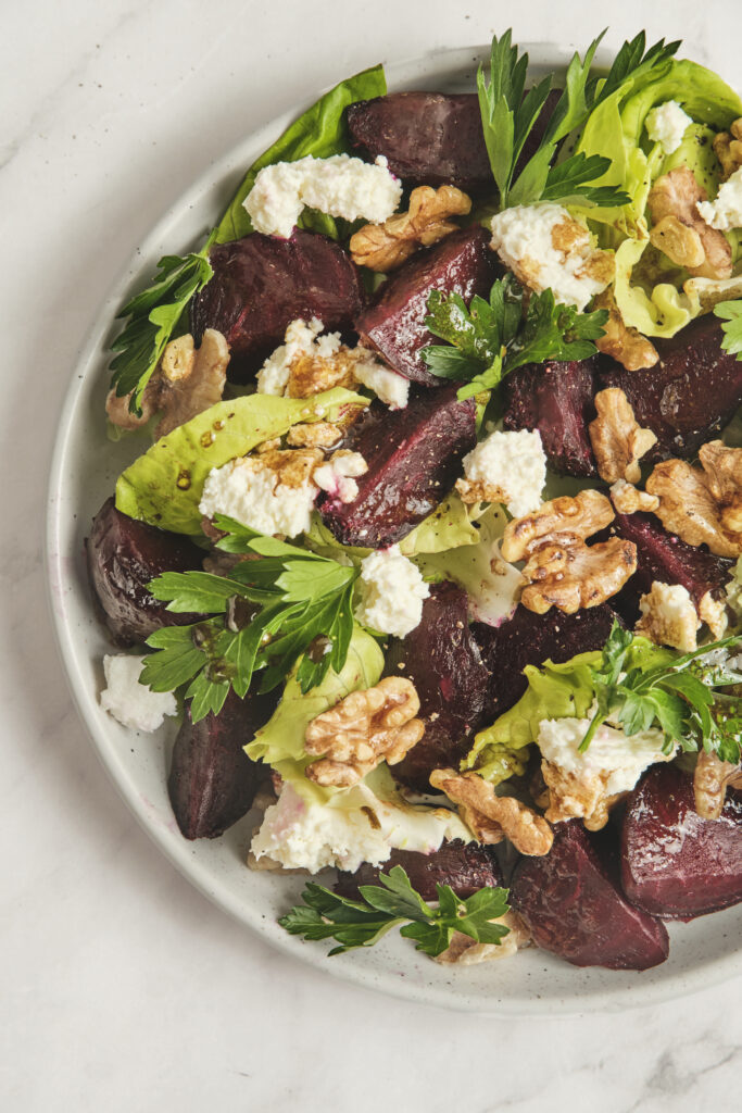 Detail of beet salad with balsamic vinaigrette and fresh herbs