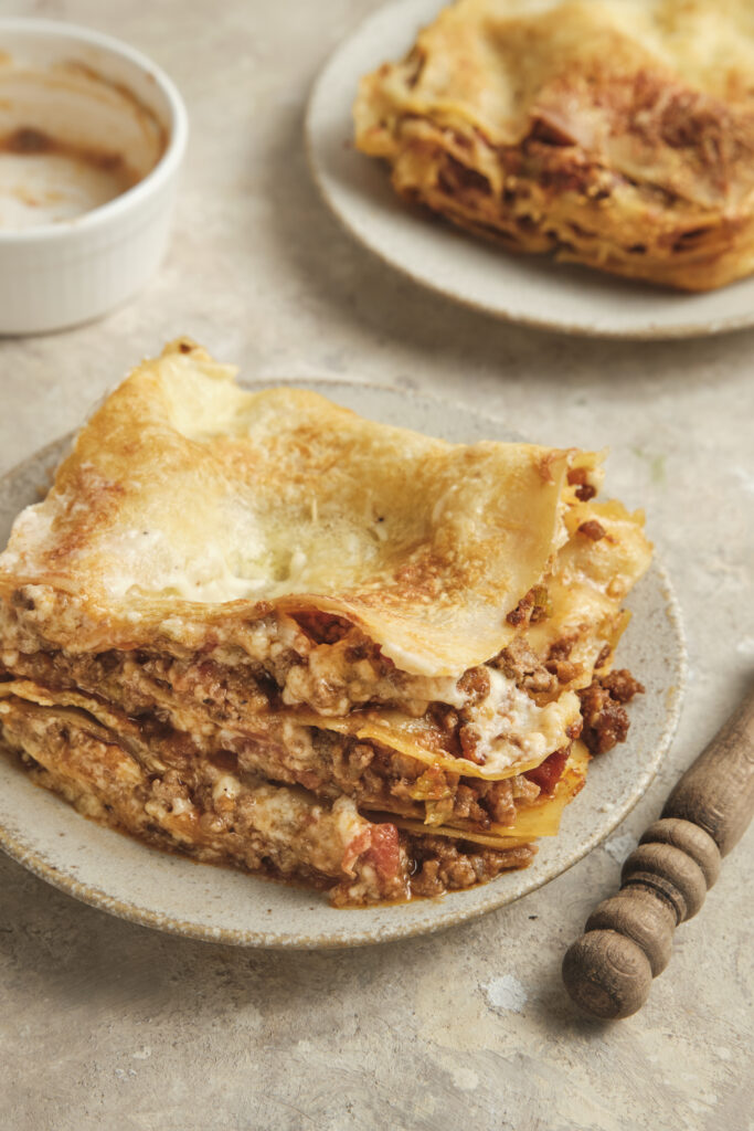 Homemade classic Italian lasagna with layers of pasta, ground beef tomato sauce, ricotta, and melted mozzarella cheese.