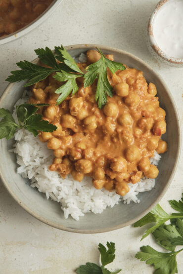 Easy Chickpea Curry served in a bowl over rice and fresh parsley