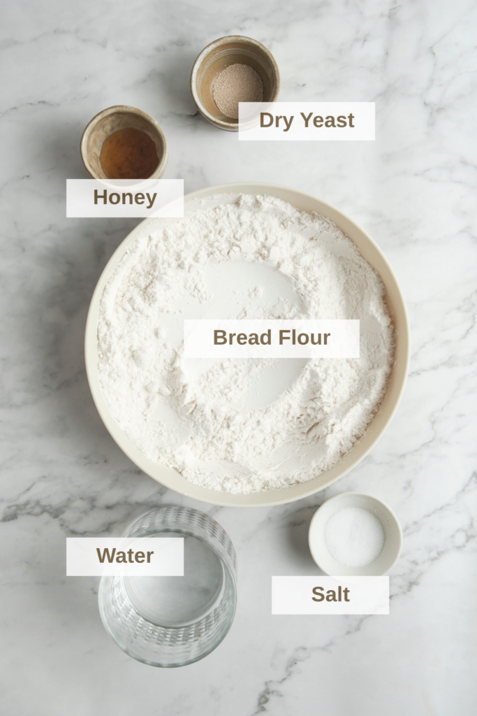 Ingredients for French baguette including bread flour, yeast, water, salt, and honey—simple base for a homemade baguette recipe..png