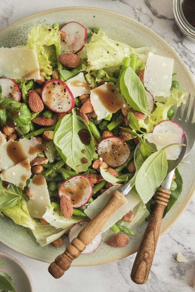 Fresh spring salad with balsamic vinaigrette in a rustic bowl