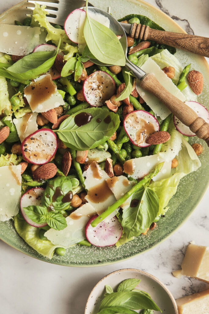Fresh spring salad with balsamic vinaigrette in a rustic bowl