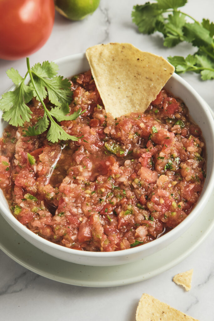 Fresh homemade salsa with ripe tomatoes, herbs, and lime—simple tomato salsa recipe made from fresh tomatoes, perfect for tacos, nachos, and everyday use.