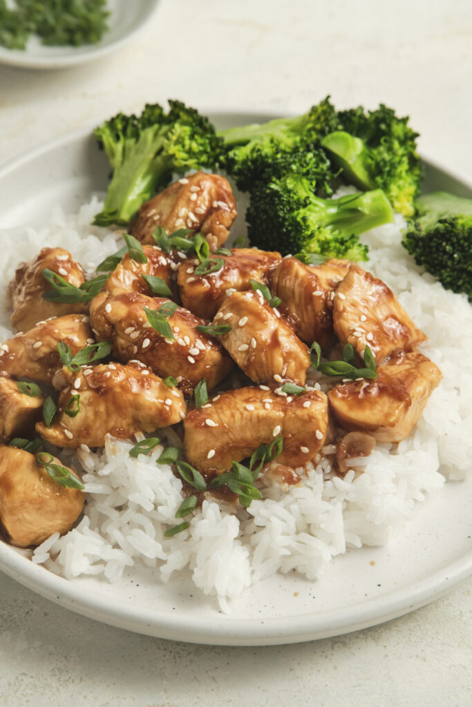 Close-up of chicken teriyaki served over fluffy rice and broccoli