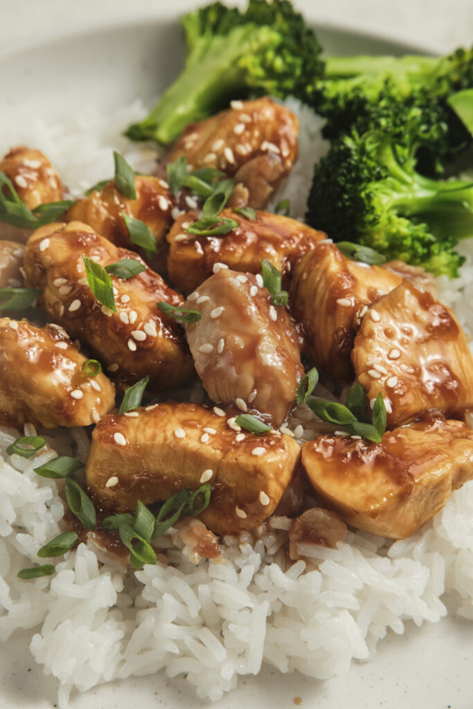 Close-up of chicken teriyaki served over fluffy rice