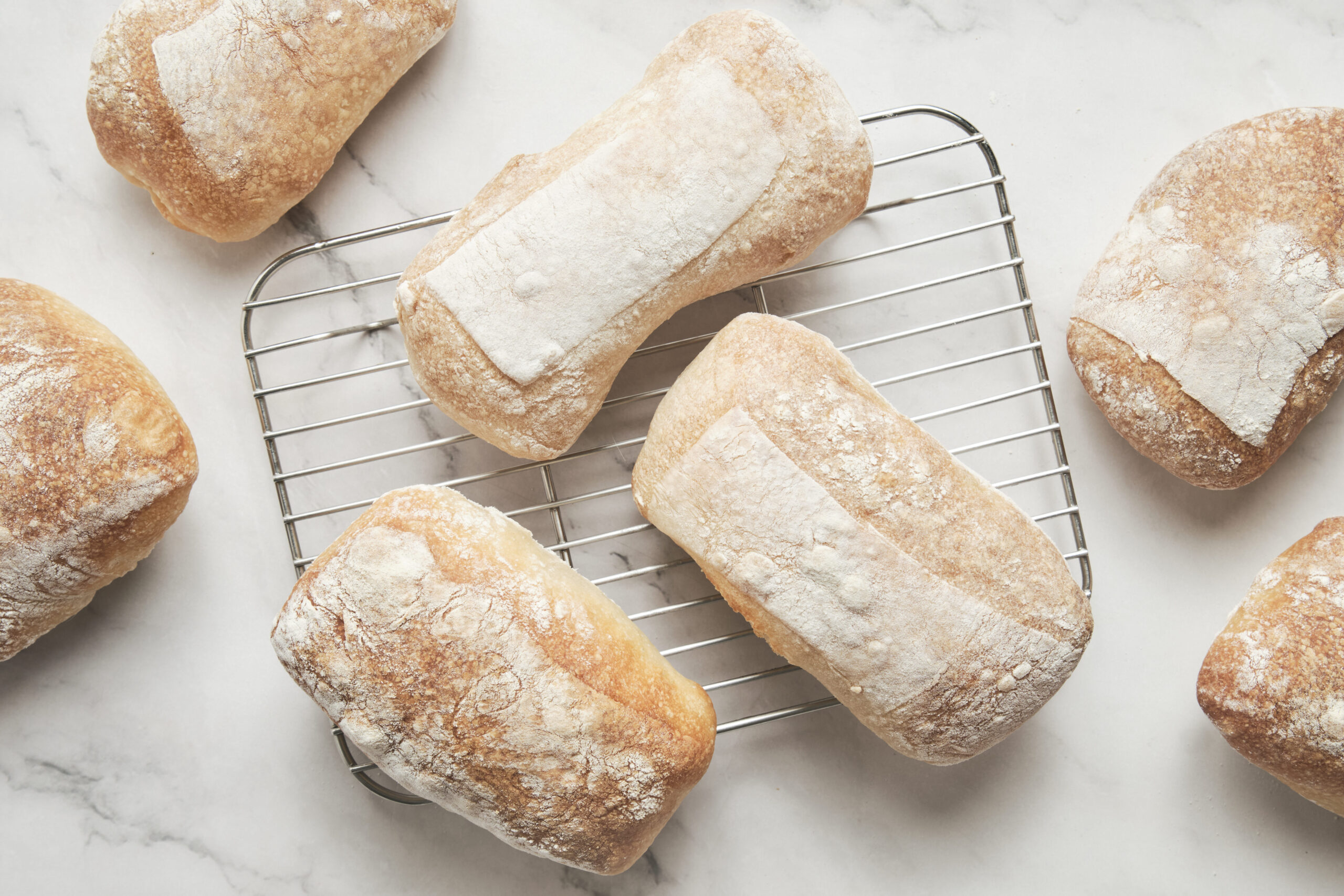 Freshly baked ciabatta bread with a crispy golden crust, rustic artisan texture.
