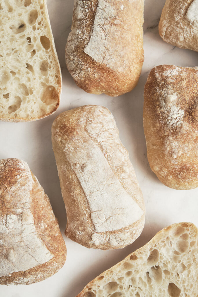 Freshly baked ciabatta bread with a crispy golden crust, rustic artisan texture.