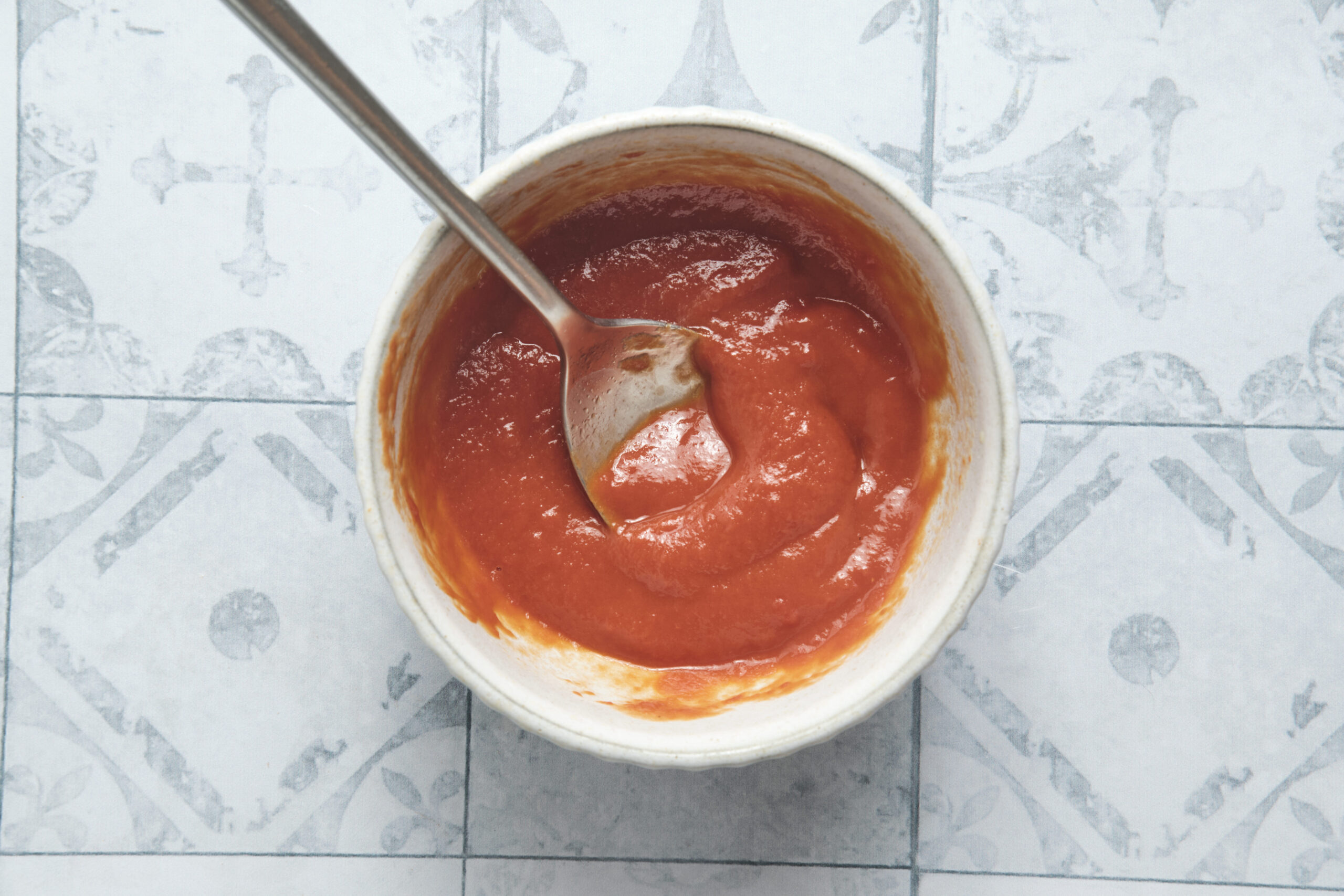 Creamy homemade doner kebab sauce mixed in a bowl with spices and paste, stirred until smooth and ready to serve with Turkish-style doner kebab.