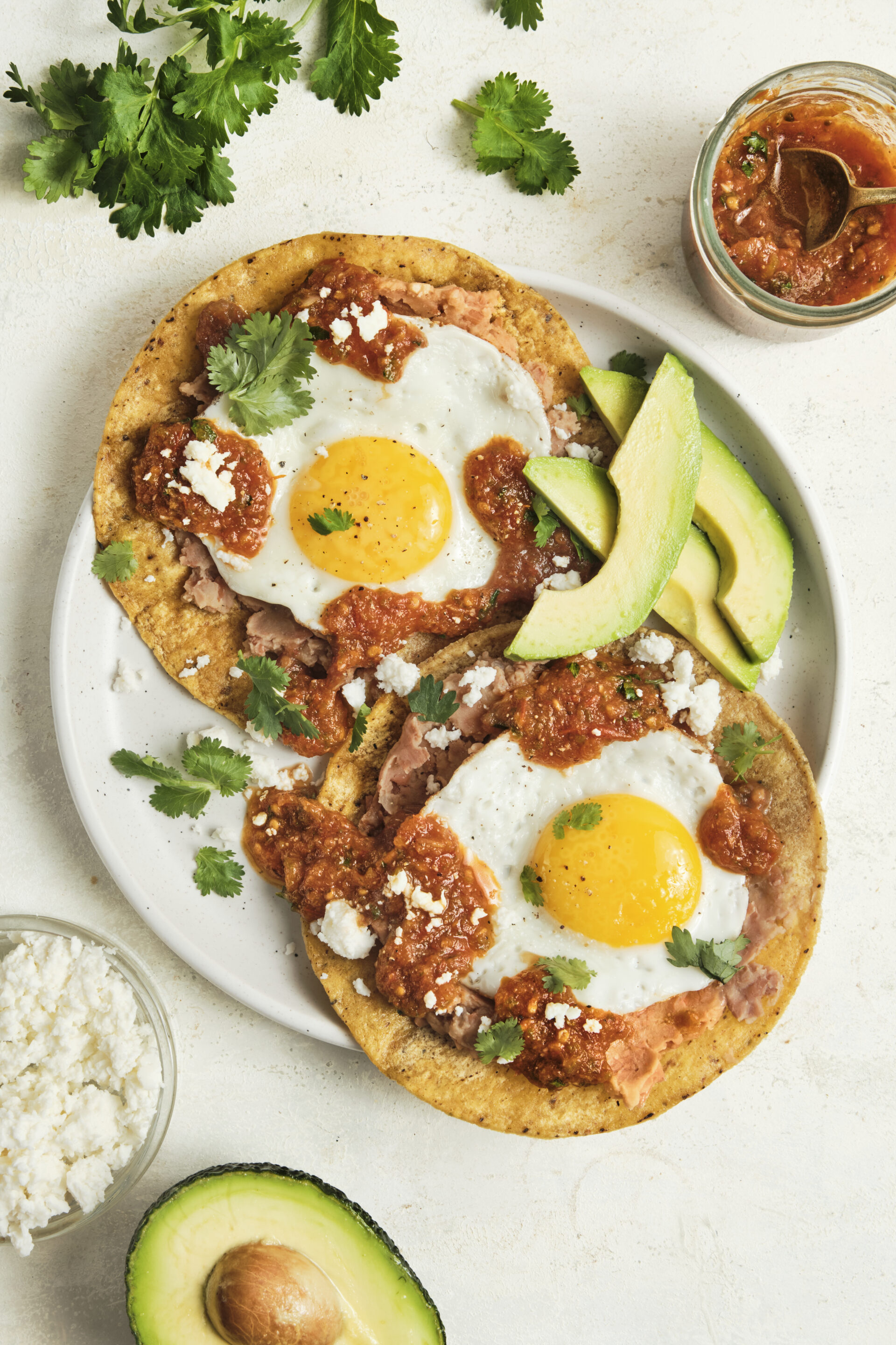 Authentic huevos rancheros topped with homemade ranchero sauce, fried eggs, and fresh cilantro, served as a classic Mexican breakfast with bold smoky flavors.