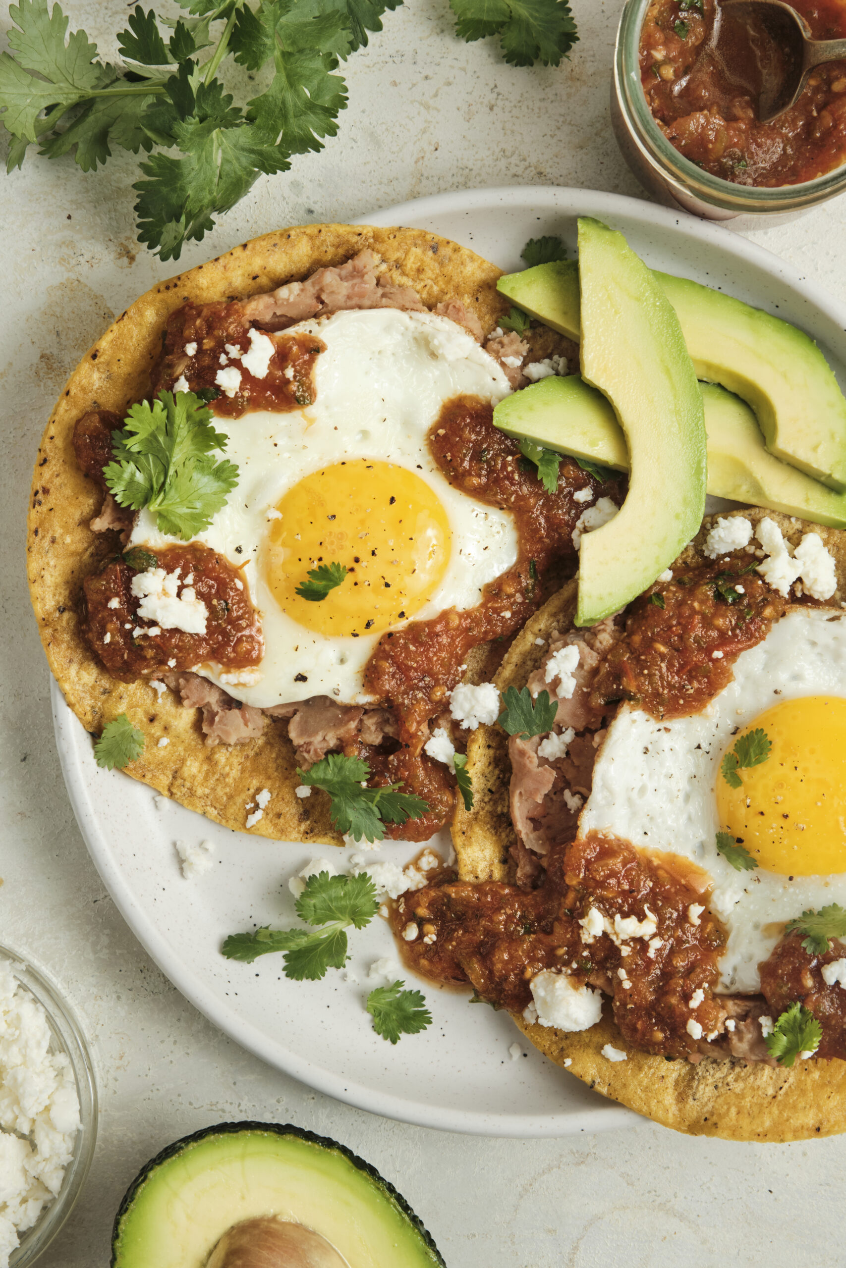 Authentic huevos rancheros topped with homemade ranchero sauce, fried eggs, and fresh cilantro, served as a classic Mexican breakfast with bold smoky flavors.