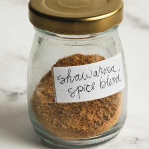 Homemade shawarma spice blend in a jar with warm spices