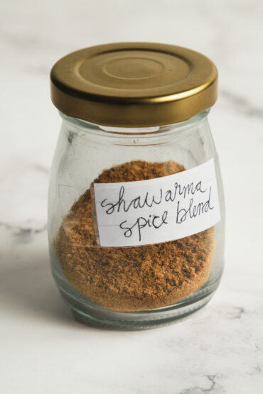 Homemade shawarma spice blend in a jar with warm spices