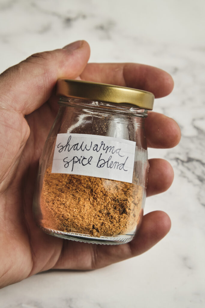 Homemade shawarma spice blend in a jar with warm spices
