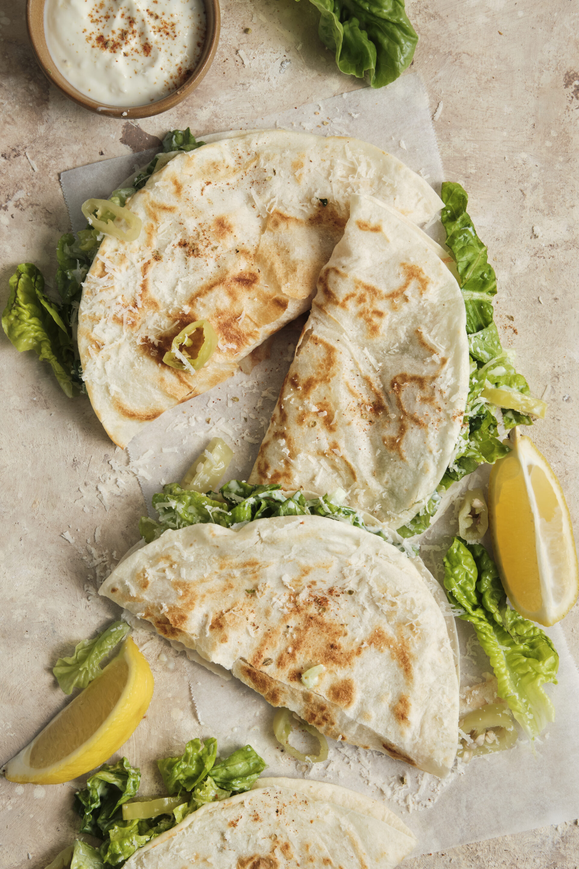 Crispy smashed chicken tacos topped with a fresh, creamy Caesar salad, and shaved parmesan,
